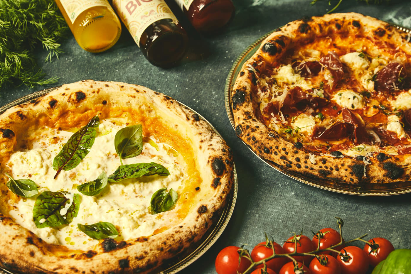 Two wood-fired pizzas with organic sodas