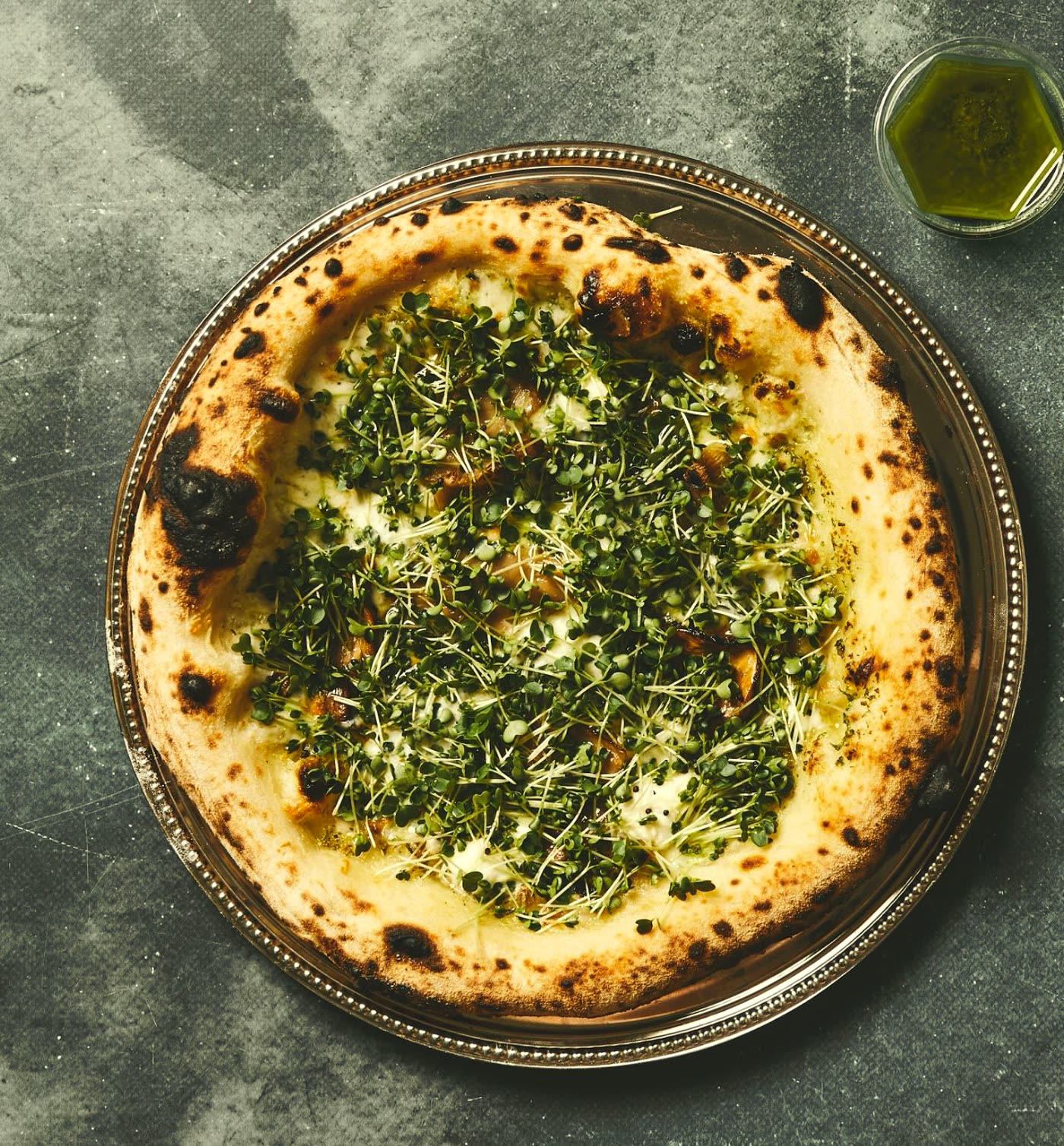 Behind the counter — a guest photographs the pizza