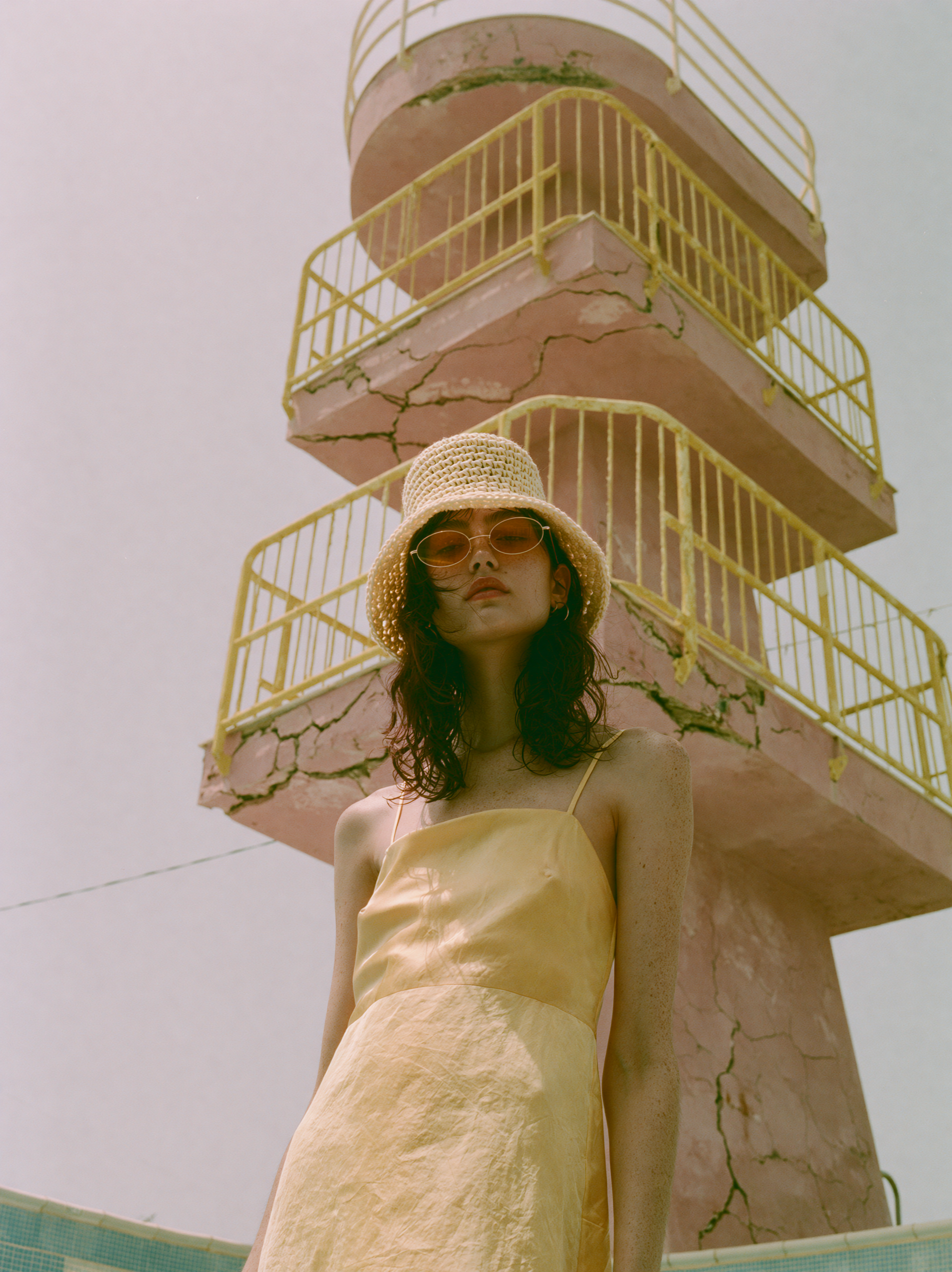 The lifeguard tower from below, the model looking past the camera