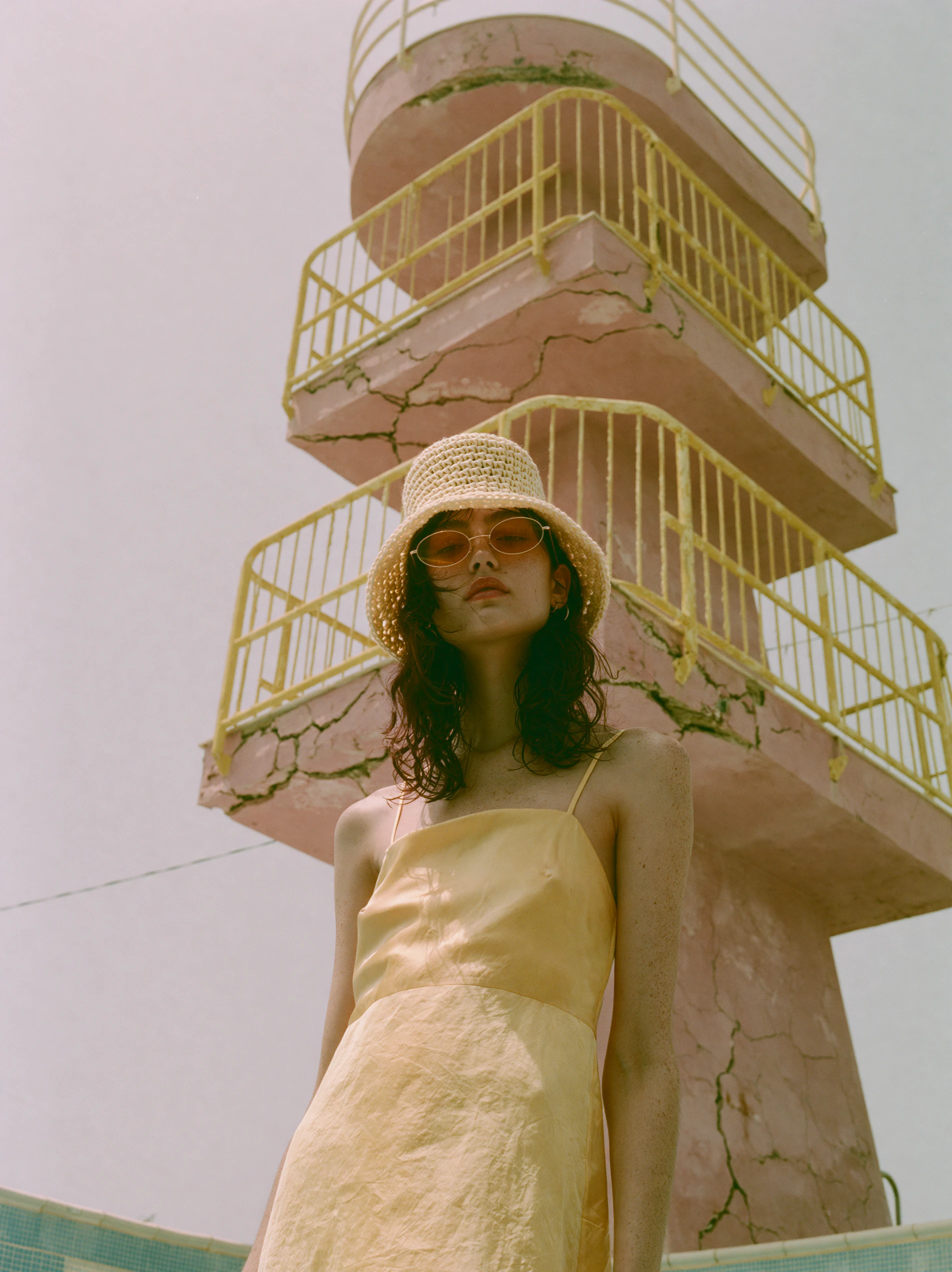 The lifeguard tower from below, the model looking past the camera