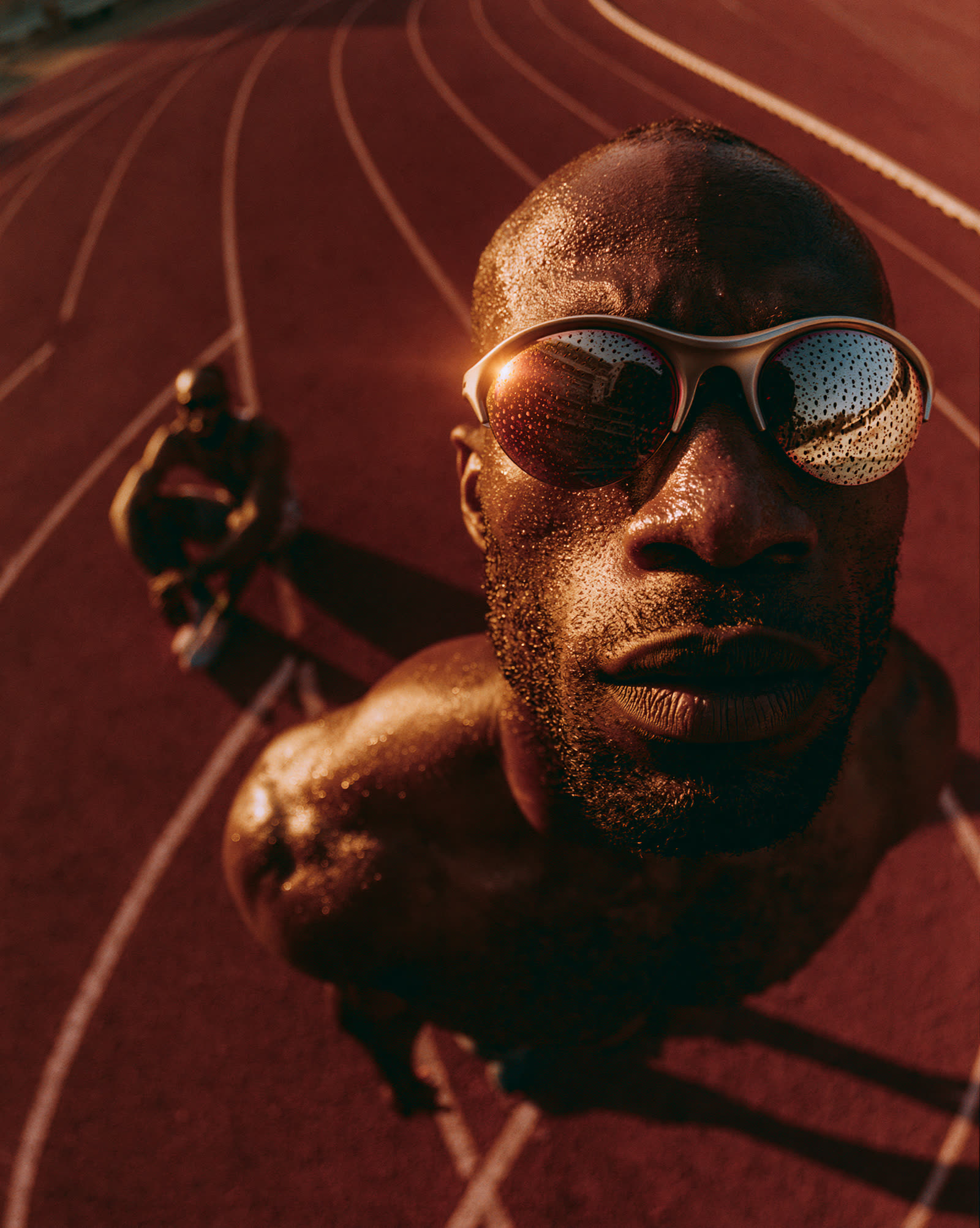 Close high-angle portrait of a runner on the red track