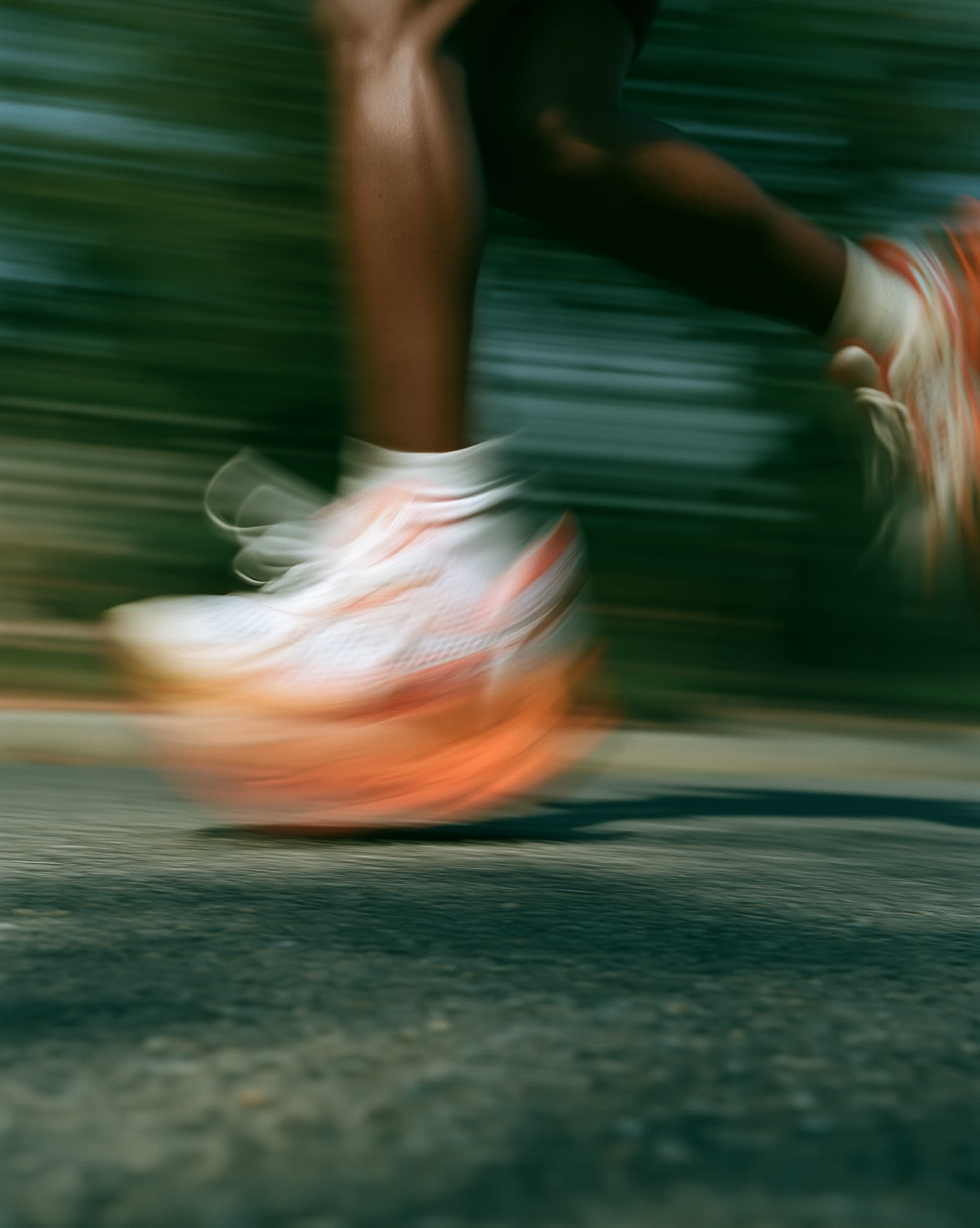 White running shoe blurred at ground level